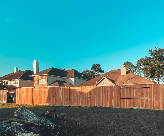 Board-on-board cedar privacy fence at golden hour — Gomez Fencing